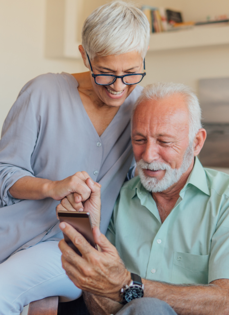 Image of an elderly couple using a phone